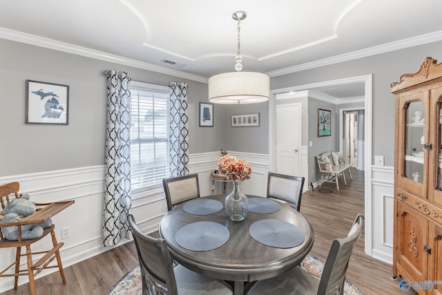 dining space with dark hardwood / wood-style floors and crown molding