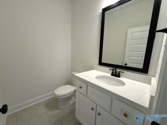 bathroom with tile patterned flooring, vanity, and toilet