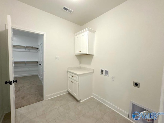 laundry area featuring cabinets, hookup for a washing machine, and hookup for an electric dryer