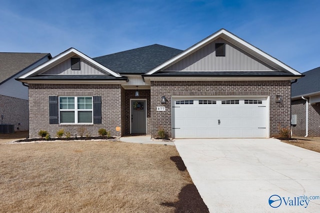 craftsman-style home with central AC, board and batten siding, concrete driveway, an attached garage, and brick siding