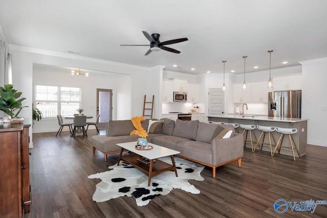 living room featuring dark wood-type flooring, recessed lighting, and ornamental molding