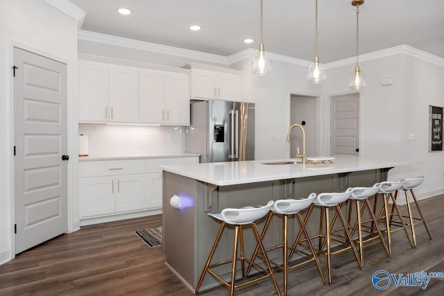 kitchen featuring ornamental molding, a sink, dark wood finished floors, white cabinetry, and stainless steel fridge with ice dispenser