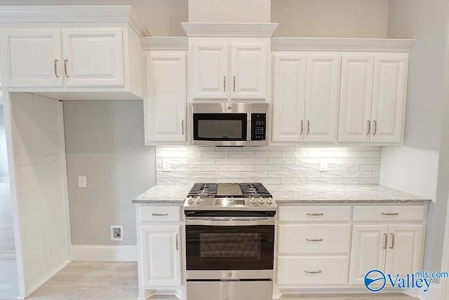 17401 Stonegate Dr, Athens, AL 35613 - kitchen featuring stainless steel appliances, baseboards, light stone countertops, and tasteful backsplash