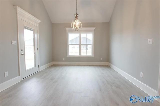 17401 Stonegate Dr, Athens, AL 35613 - empty room with healthy amount of natural light, a chandelier, lofted ceiling, light wood-type flooring, and baseboards