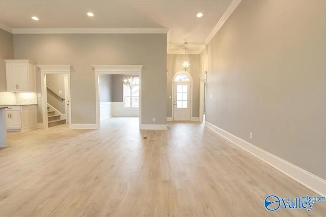 17401 Stonegate Dr, Athens, AL 35613 - unfurnished living room with crown molding, stairway, baseboards, light wood-type flooring, and recessed lighting