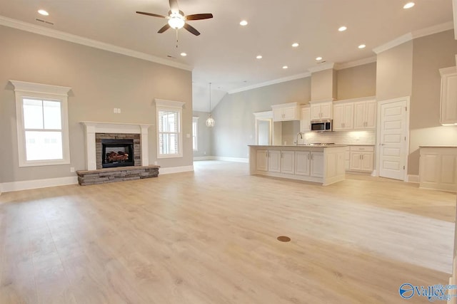 17401 Stonegate Dr, Athens, AL 35613 - unfurnished living room featuring ceiling fan, baseboards, ornamental molding, recessed lighting, and a fireplace