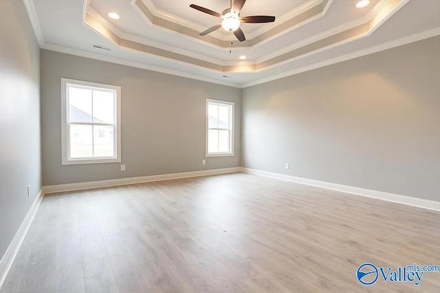 17401 Stonegate Dr, Athens, AL 35613 - spare room featuring a raised ceiling, a ceiling fan, wood finished floors, crown molding, and baseboards