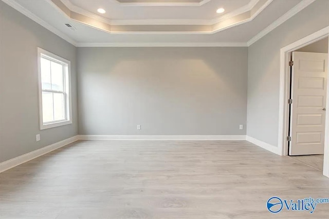 17401 Stonegate Dr, Athens, AL 35613 - spare room featuring a tray ceiling, ornamental molding, light wood-style flooring, recessed lighting, and baseboards