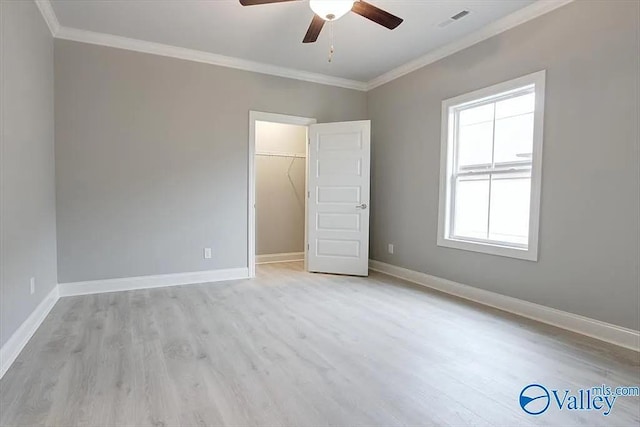 17401 Stonegate Dr, Athens, AL 35613 - unfurnished bedroom featuring crown molding, light wood finished floors, baseboards, a spacious closet, and a closet