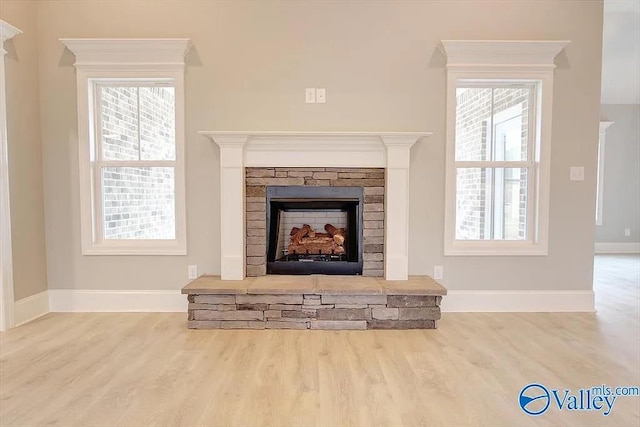 17401 Stonegate Dr, Athens, AL 35613 - detailed view of wood finished floors, a stone fireplace, and baseboards