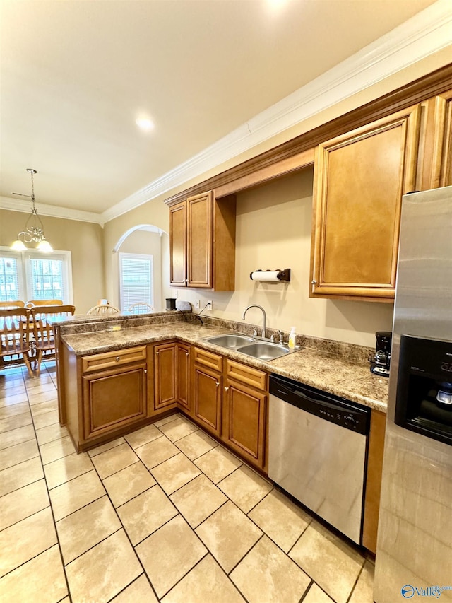 kitchen featuring crown molding, appliances with stainless steel finishes, a sink, and brown cabinets