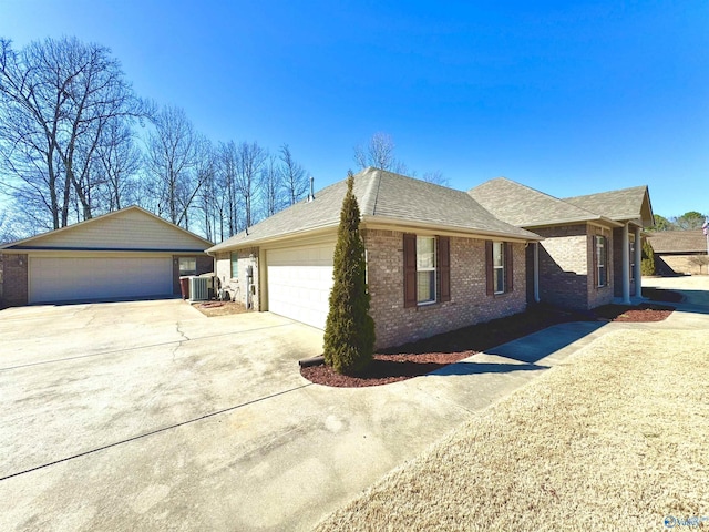 view of property exterior with a shingled roof, brick siding, and central AC unit