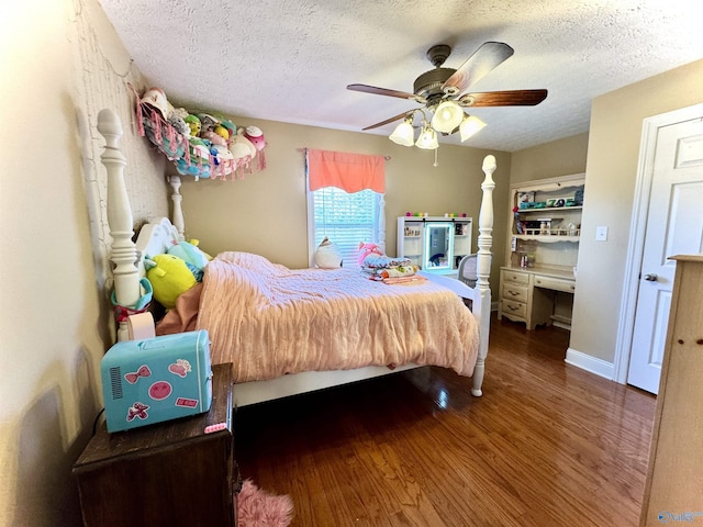 bedroom featuring ceiling fan, a textured ceiling, and wood finished floors