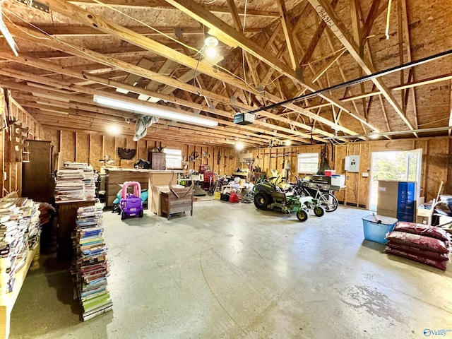 garage featuring electric panel and a garage door opener