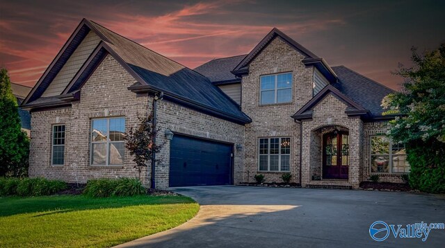 craftsman-style house featuring a garage and a yard