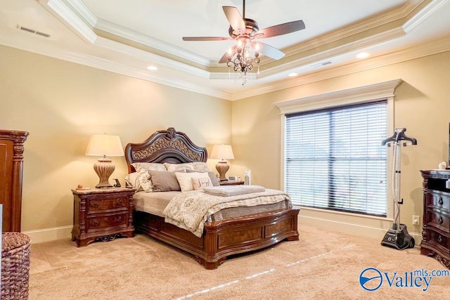 bedroom featuring ceiling fan, a raised ceiling, ornamental molding, and light colored carpet