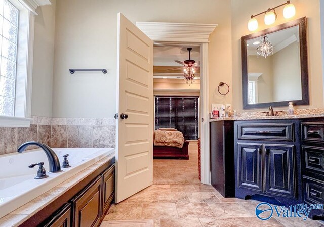 bathroom featuring a wealth of natural light, crown molding, a bathing tub, and vanity