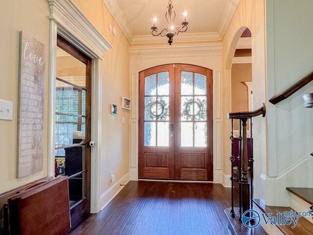 entryway featuring dark wood-type flooring, french doors, and ornamental molding