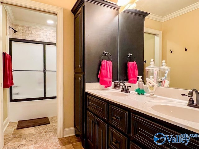 bathroom with tile patterned floors, combined bath / shower with glass door, double sink vanity, and ornamental molding