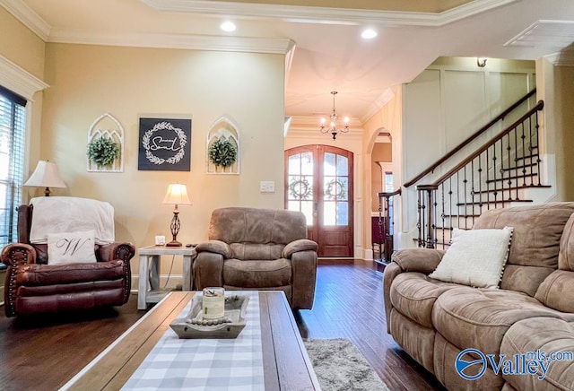 living room with crown molding, dark wood-type flooring, and a chandelier