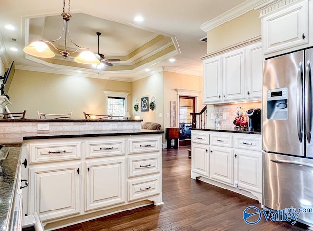 kitchen featuring crown molding, dark hardwood / wood-style flooring, decorative backsplash, decorative light fixtures, and stainless steel refrigerator with ice dispenser