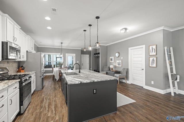 1530 Trek St NE, Huntsville, AL 35811 - kitchen featuring stainless steel appliances, an island with sink, ornamental molding, white cabinets, and baseboards