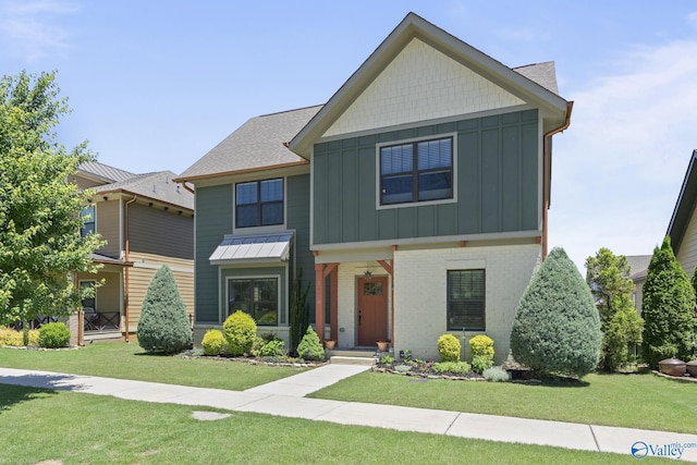 1530 Trek St NE, Huntsville, AL 35811 - craftsman-style house with board and batten siding, a front yard, and roof with shingles