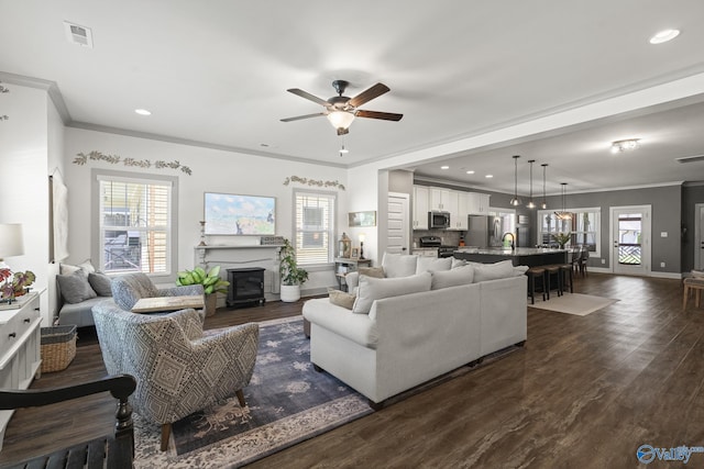 1530 Trek St NE, Huntsville, AL 35811 - living area featuring ornamental molding, a ceiling fan, baseboards, plenty of natural light, and recessed lighting