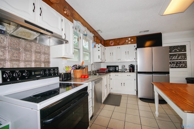 kitchen with stainless steel appliances, sink, light tile patterned floors, and white cabinets