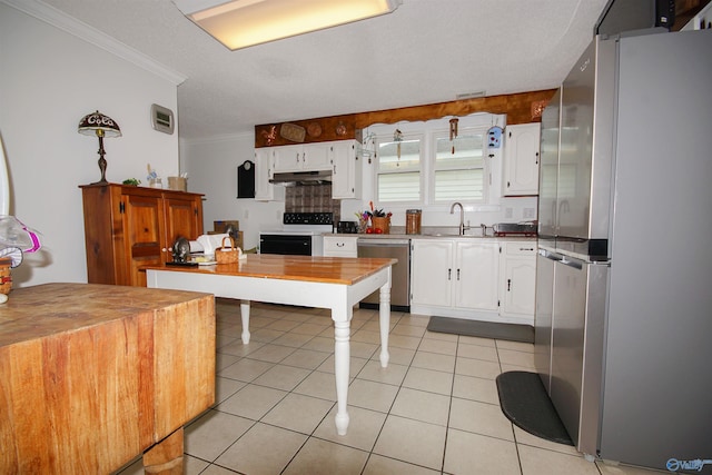 kitchen featuring sink, light tile patterned floors, crown molding, white cabinetry, and stainless steel appliances