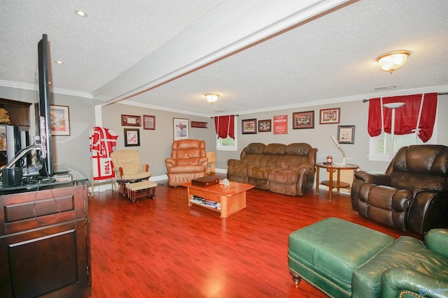 living room featuring wood-type flooring, ornamental molding, and a textured ceiling