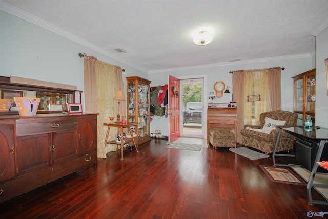 sitting room featuring ornamental molding, dark hardwood / wood-style floors, and a textured ceiling