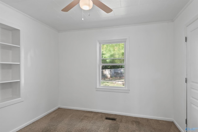 unfurnished room featuring ornamental molding, carpet, and ceiling fan