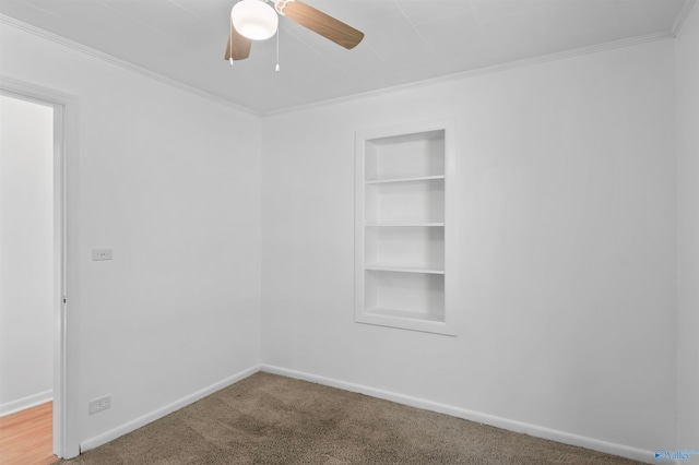 unfurnished room with crown molding, built in features, and carpet flooring