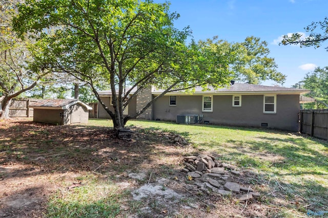 back of property with a storage unit and central AC unit