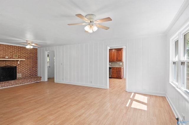 unfurnished living room featuring light hardwood / wood-style flooring, ceiling fan, and plenty of natural light