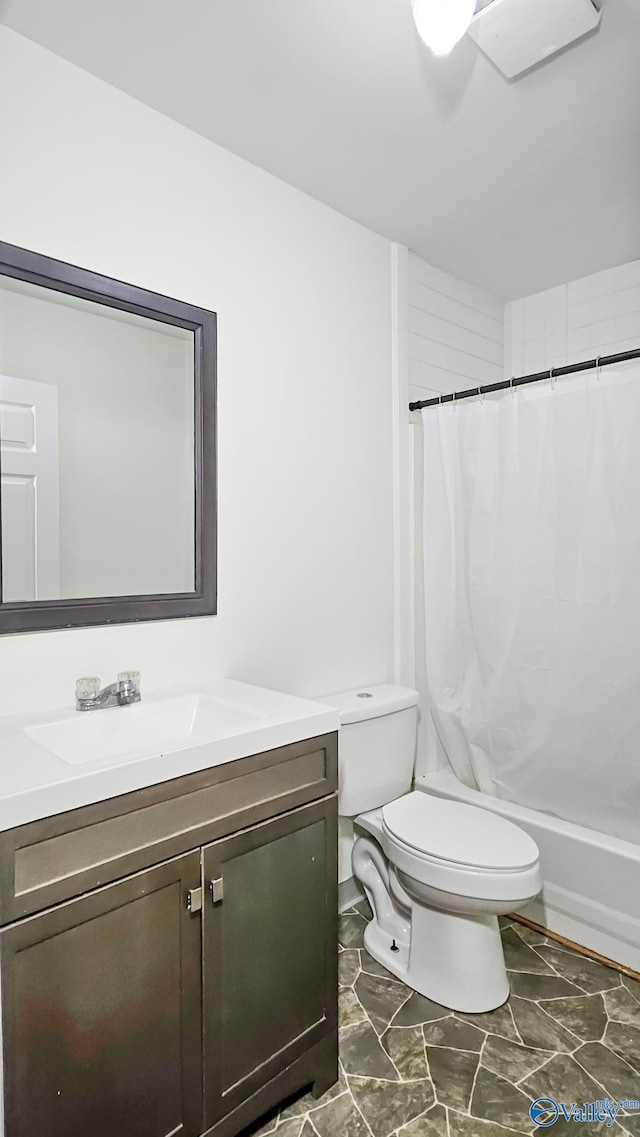 full bathroom featuring shower / bath combination with curtain, toilet, and vanity