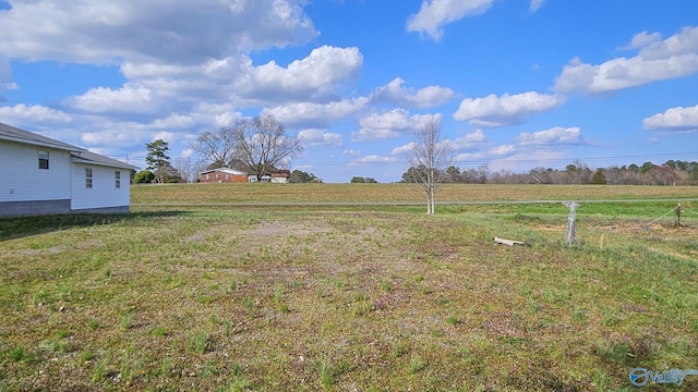 view of yard with a rural view