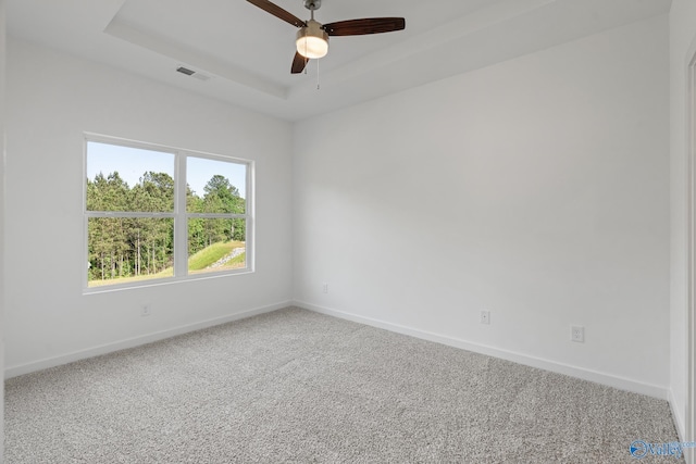 6219 Taramore Ln NW, Huntsville, AL 35806 - unfurnished room featuring visible vents, a tray ceiling, baseboards, and carpet floors