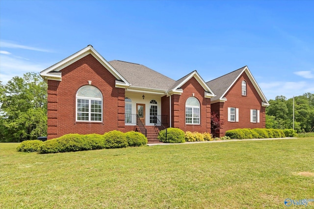 view of front of home featuring brick siding and a front lawn