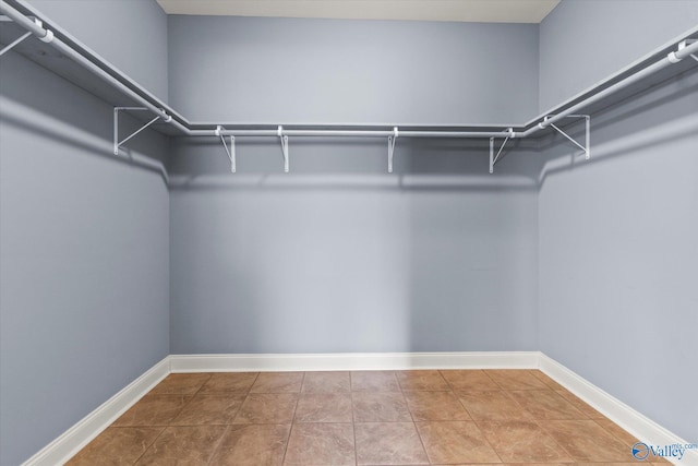 walk in closet with tile patterned flooring
