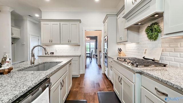 17583 Maree Dr, Athens, AL 35613 - kitchen featuring a sink, stainless steel appliances, tasteful backsplash, light stone counters, and dark wood-style floors