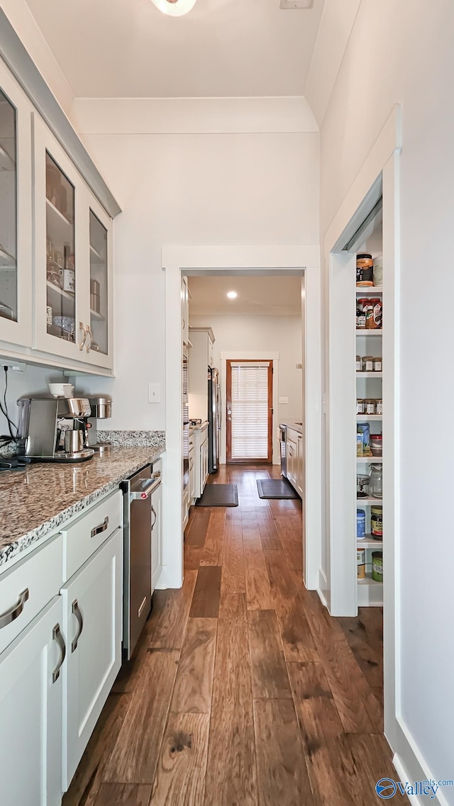 17583 Maree Dr, Athens, AL 35613 - interior space featuring light stone counters, stainless steel appliances, dark wood-style floors, and glass insert cabinets