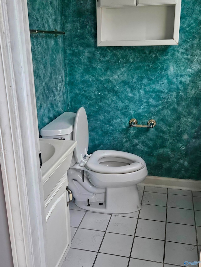 bathroom featuring tile patterned flooring, vanity, and toilet