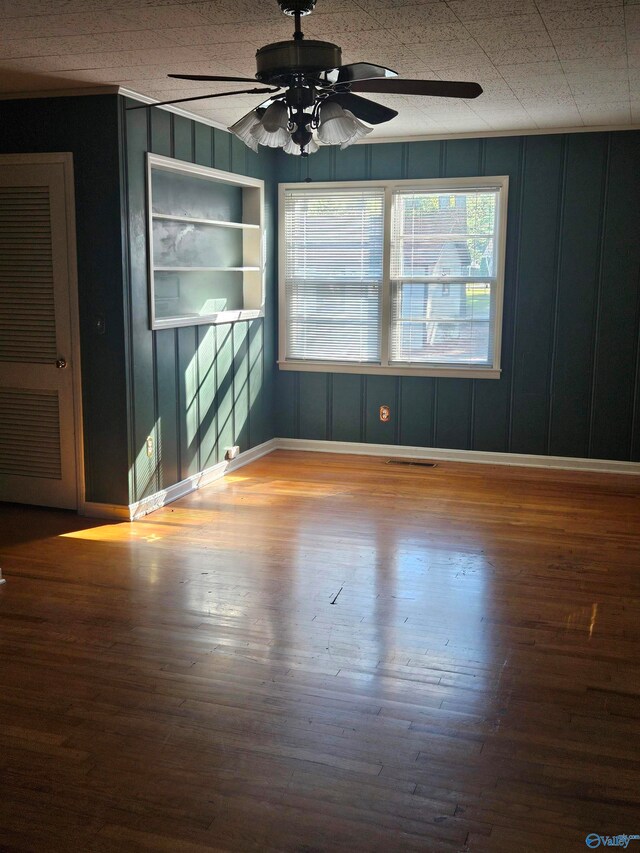 empty room with ceiling fan and wood-type flooring