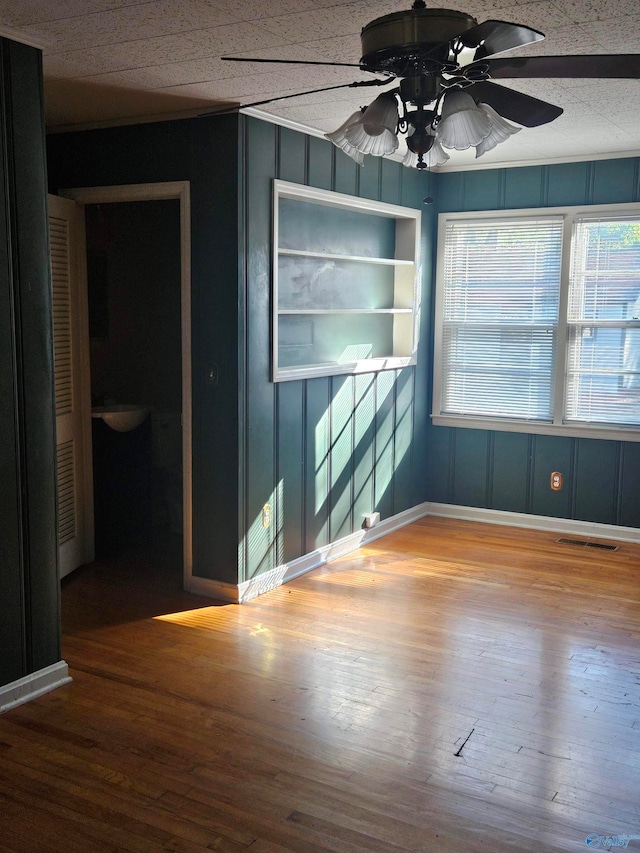 spare room with hardwood / wood-style flooring and ceiling fan