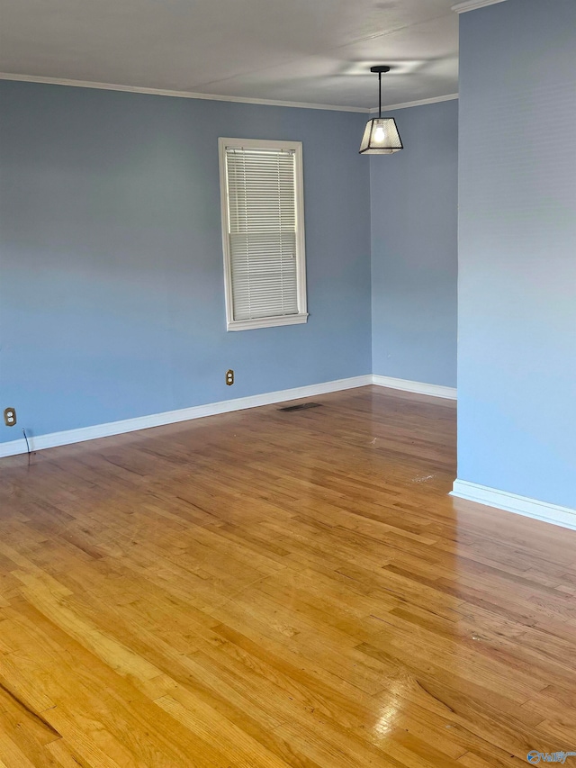 unfurnished room with light hardwood / wood-style flooring and ornamental molding