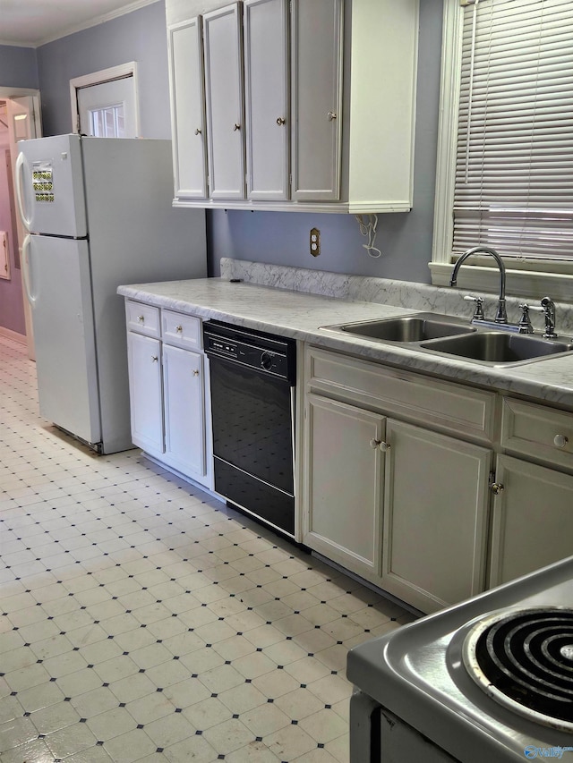 kitchen with white refrigerator, sink, and black dishwasher