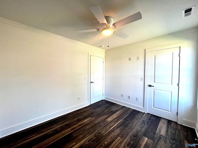 unfurnished room with crown molding, ceiling fan, and dark hardwood / wood-style flooring