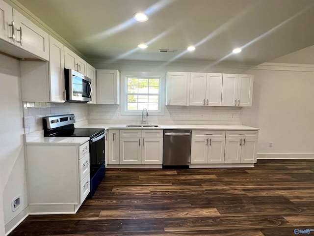 kitchen with stainless steel appliances, white cabinets, dark wood-type flooring, sink, and ornamental molding